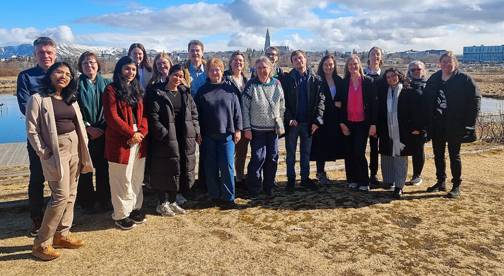 Traditional group photo, taken outside. About 20 people.